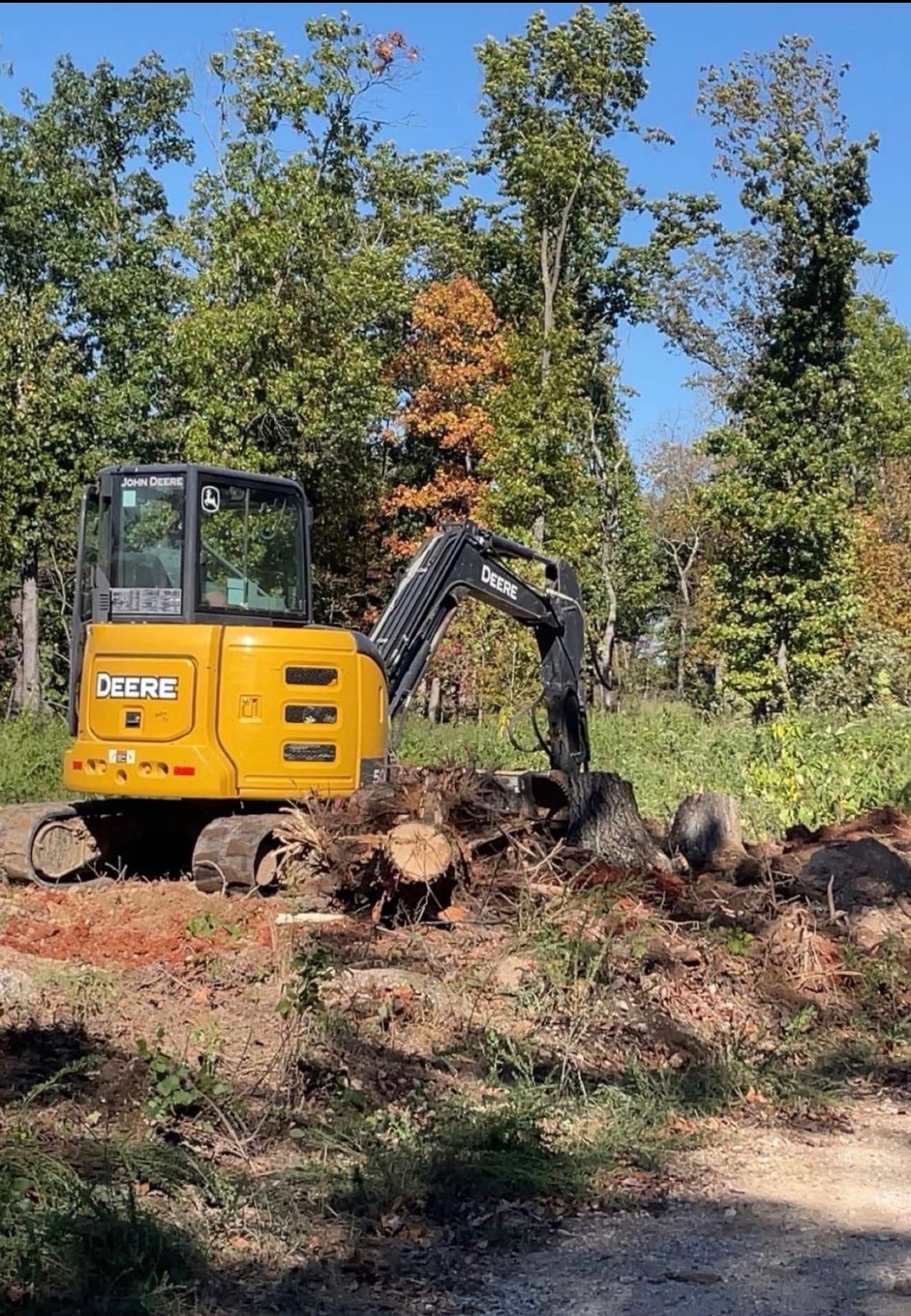 John Deere mini excavator doing stump removal in Randolph County Missouri